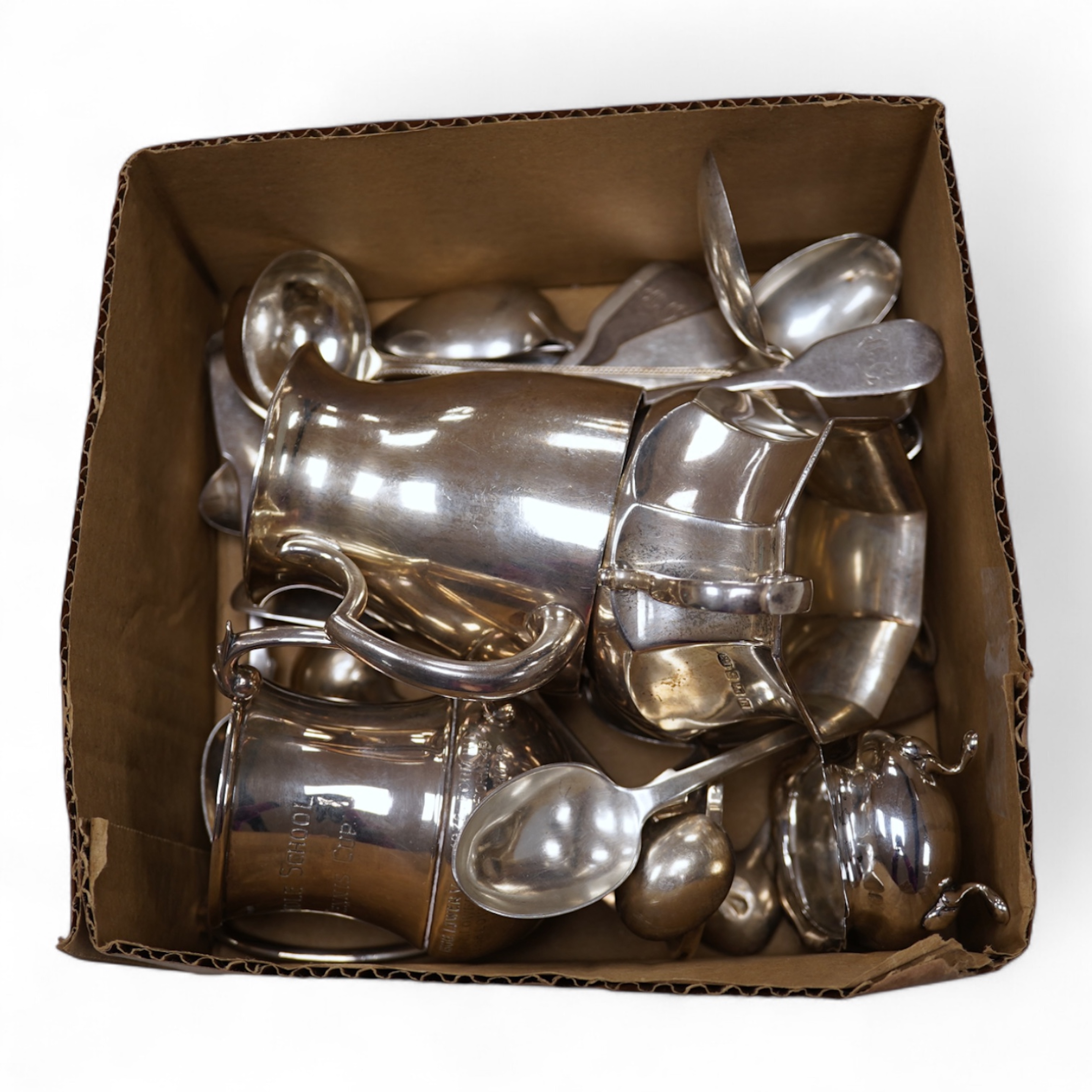 A George V silver christening mug, George Howson, Sheffield, 1934, height 77mm, together with one other silver mug, a small silver two handled cup, a silver salt and a small quantity of assorted silver flatware, 22.7oz.